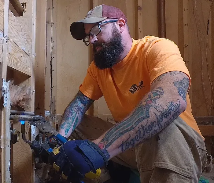 Klemetsrud employee working on pipes